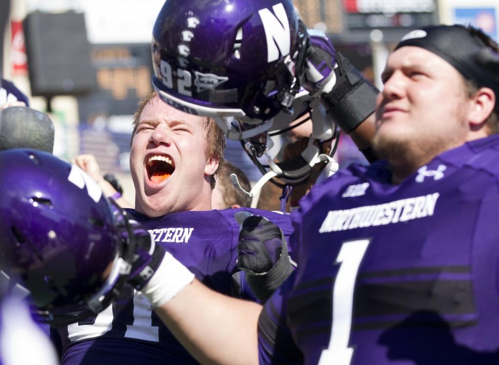 Northwestern defensive linemen Brian Arnfelt (left) and Bo Cisek (right) celebrate after the Wildcats win over Indiana. As of the fifth week of its season, Northwestern is the only undefeated team in the Legends division.