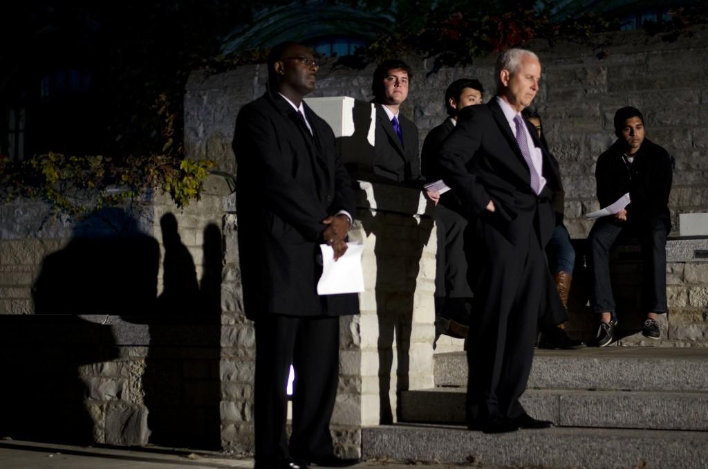 Burgwell Howard, assistant vice president for student engagement, and University President Morton Schapiro (left to right in the foreground) watch on as student commemorate Harsha Maddula, the missing student whose body was found in Lake Michigan on Thursday evening.