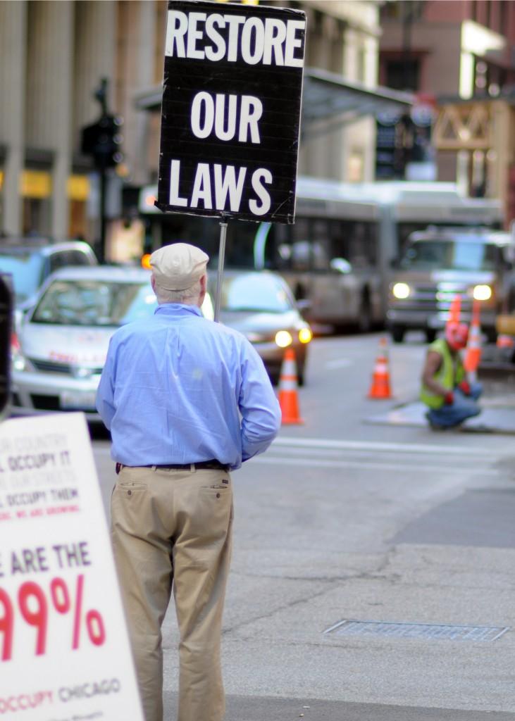 A protester holds a sign at an Occupy protest in 2011.