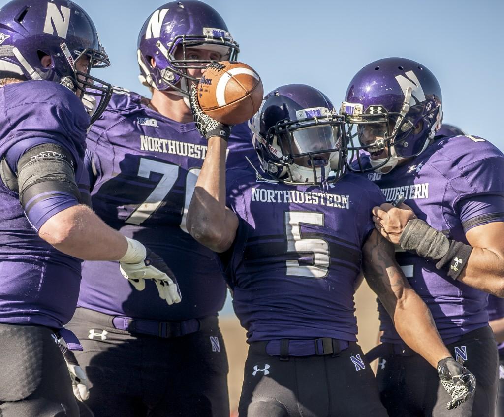 Venric Mark celebrates the first of his three rushing touchdowns in the first half. The junior running back had 97 yards rushing in the first half to propel NU to a 28-0 lead.