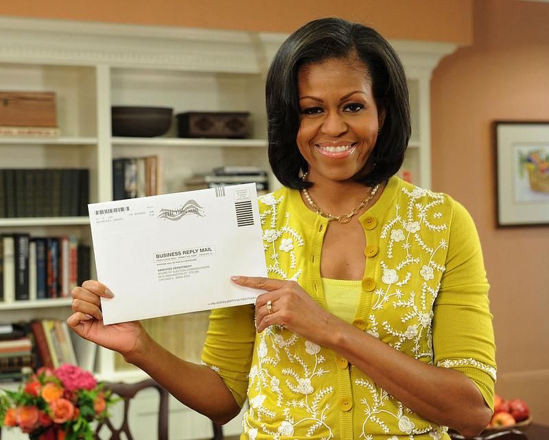 First Lady Michelle Obama displays her Illinois absentee ballot for the presidential election. On Monday, she mailed her early vote from the White House.