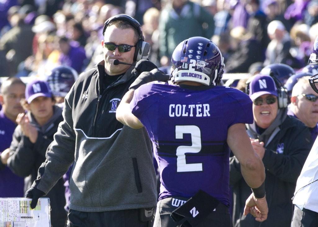 Northwestern+coach+Pat+Fitzgerald+and+quarterback+Kain+Colter+celebrate+after+Colters+first+touchdown+run+in+the+opening+half+against+Iowa.+Colter+gained+66+yards+and+two+touchdowns+on+11+carries+in+the+frame.+