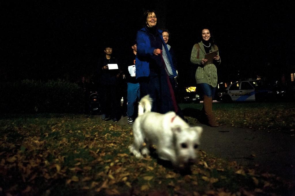 Evanston Mayor Elizabeth Tisdahl (center) tugs on her dog Comet’s leash while participating in a walk organized by Associated Student Government senator Jane Gilmore (right) to identify poorly lit off-campus areas.