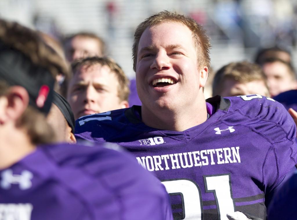 Defensive lineman Brian Arnfelt sings the Northwestern fight song after the Wildcats’ win against Iowa. Arnfelt posted one sack Saturday.