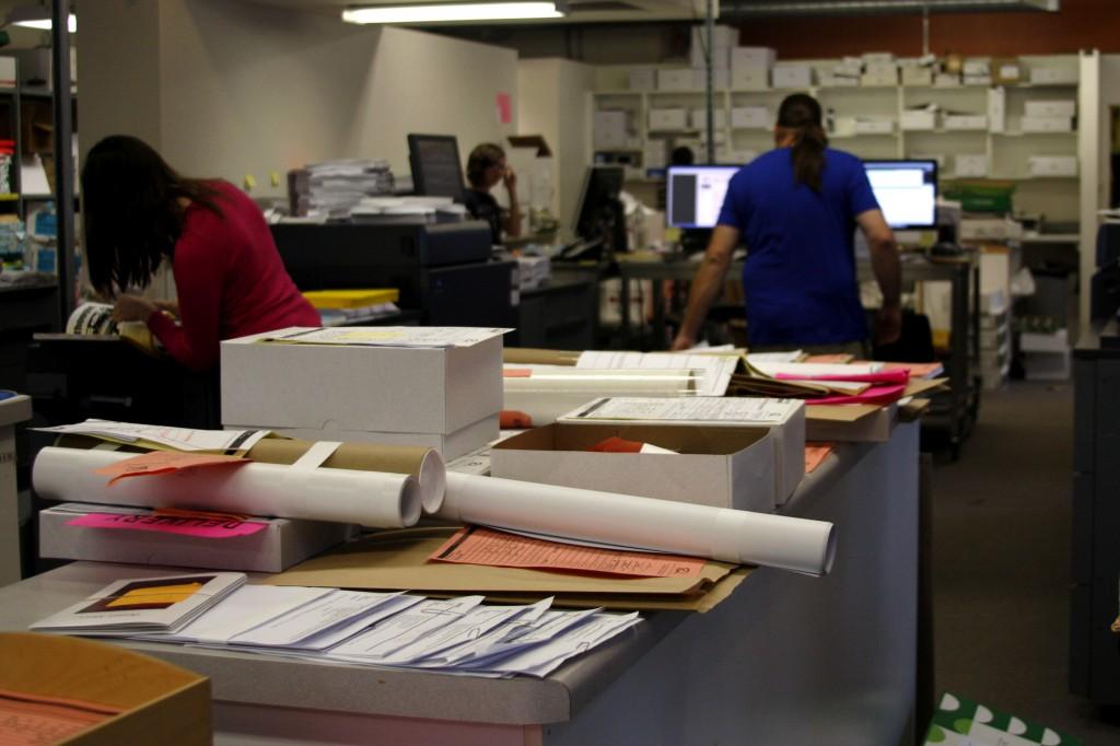 Course packets lie on the counter at Quartet Copies in downtown Evanston. Quartet Copies co-owner Chris Linster said short-staffing and the late start of Northwestern’s Fall Quarter has left the store backlogged.