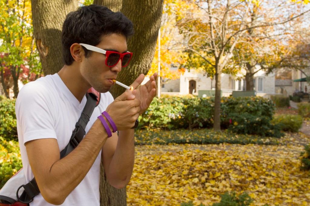 McCormick freshman Nikhil Pai smokes a cigarette in the sorority quad. Cook County is considering a tax increase on cigarettes that would cause the price of a pack to rise by $1. 
