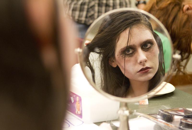 Weinberg freshman Marie Peeples puts the finishing touches on her zombie look for Jumpstarts Zombie Walk Monday night at the Evanston Public Library.