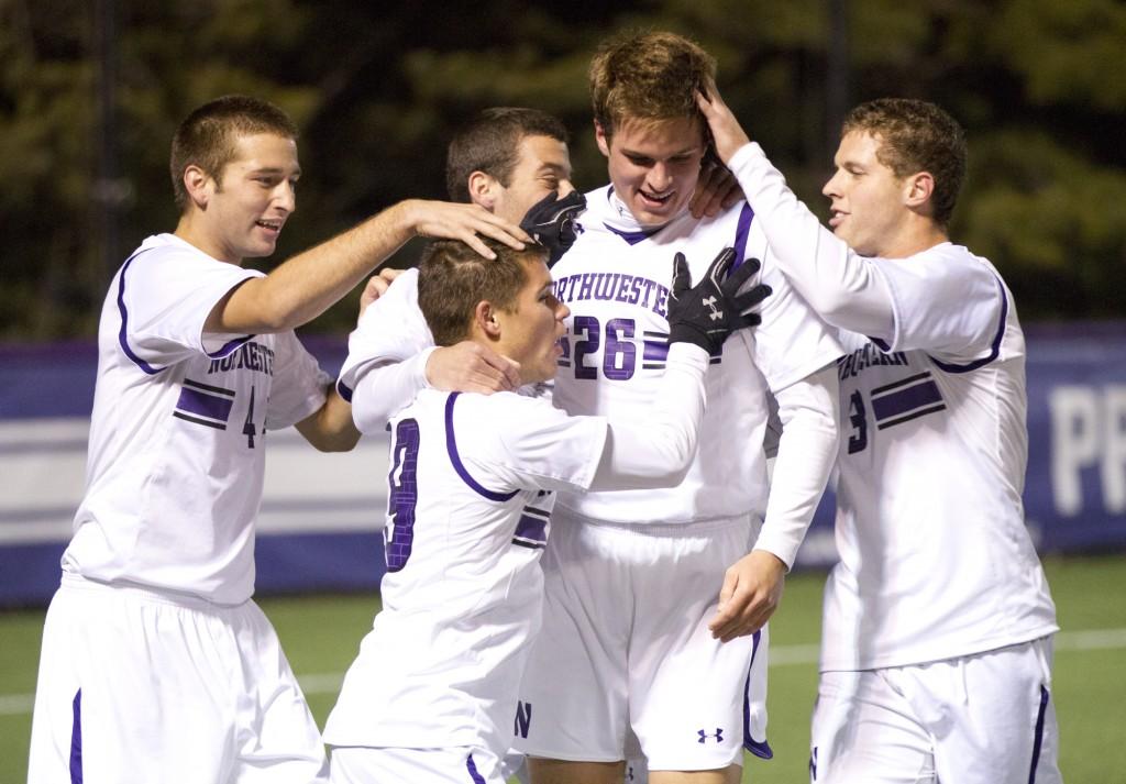 Northwestern midfielfer Grant Wilson (No. 26) celebrates with his teammates. Wilson had an assist on one of the Wildcats two goals Wednesday night. 
