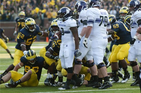 The Wolverines stop the Wildcats on a fourth-and-one play in overtime Saturday. The Wolverines won the game 38-31. 