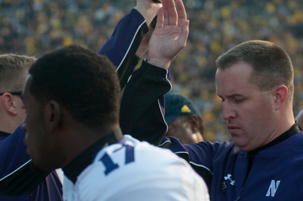 Coach Pat Fitzgerald leads his team back into the locker rooms after the Saturdays game against Michigan. The close game ended as a disappointing loss for the Wildcats, who fell to the Wolverines in overtime 38-31. 