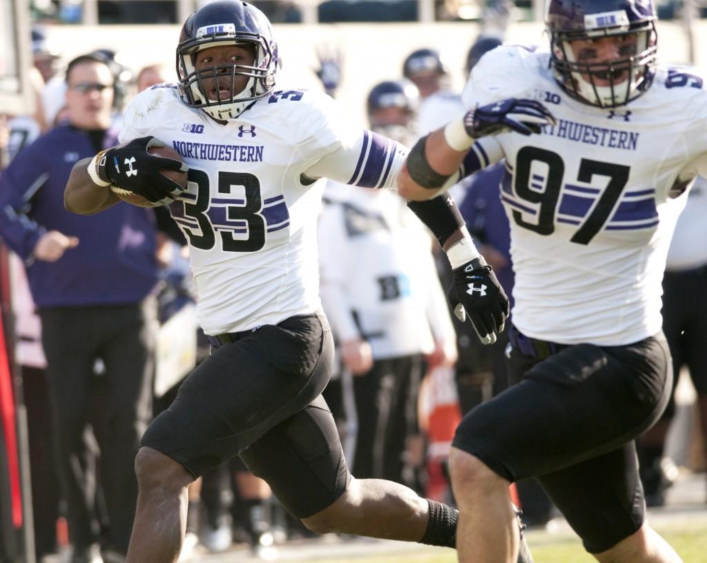 Northwestern linebacker David Nwabuisi (33) returns a third-quarter interception for a touchdown. The Wildcats forced four turnovers in Saturdays game.