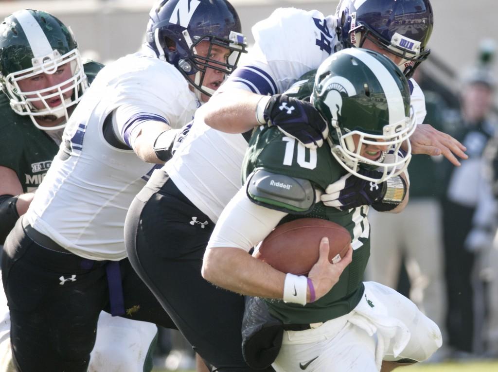 Northwestern defensive lineman Dean Lowry (94) brings down Michigan State quarterback Andrew Maxwell at the Spartans three-yard line. It was the only sack of the half for the Wildcats.