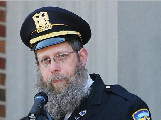 Rabbi Hillel Klein, wearing his uniform as an chaplain of the Evanston Police Department, speaks at an event. Klein has been at the center of an ongoing controversy regarding Northwestern’s disaffiliation with the Chabad House.