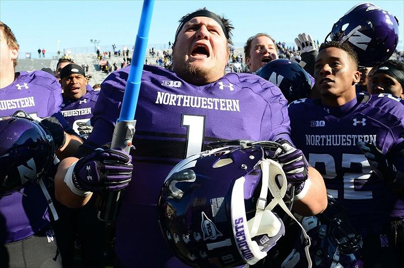 Northwestern+defensive+lineman+Bo+Cisek+takes+a+lightsaber+from+the+crowd+to+lead+the+band+in+the+fight+song+after+the+Wildcats+defeat+of+Iowa+on+Oct.+27.+Cisek+has+one+of+the+biggest+characters+on+the+team%2C+but+he+said+he+knows+exactly+where+to+draw+the+line+when+its+time+to+be+serious.