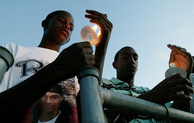 Evanston teenager Justin Murray (right) reflects during a community vigil for the death of 17-year-old Darryl Shannon Picket in 2007. Murray was gunned down Thursday near Evanston Township High School.
