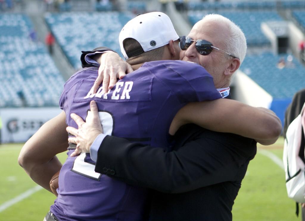 Northwestern quarterback Kain Colter hugs Northwestern President Morton Schapiro after the Wildcats’ win over Mississippi State at the Gator Bowl on Tuesday.