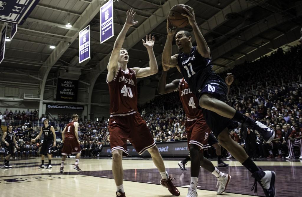 Northwestern guard Reggie Hearn (11) drives past Indiana center Cody Zeller (40) and guard Victor Oladipo (4). Hearn led the Wildcats with 22 points in Sundays loss.