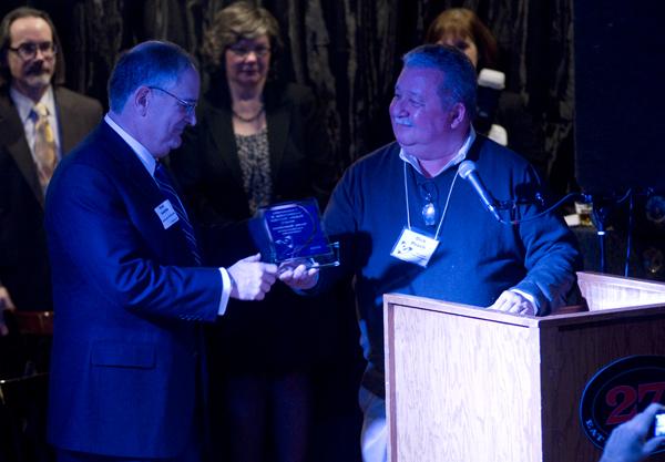 Eugene Sunshine, NU senior vice president for business and finance, accepts an award from the Evanston Chamber of Commerce at its annual meeting Wednesday night.  
