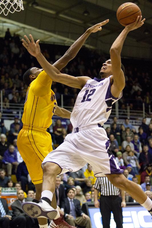 Graduate student Jared Swopshire attempts a shot against Minnesota. Swopshires gritty effort propelled the Wildcats to an upset of the No. 12 Golden Gophers in Evanston.