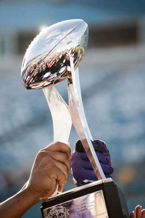 The Gator Bowl trophy, the first bowl trophy won by the Wildcats since 1949, is held up at the end of Saturdays game.