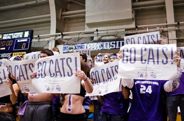 Northwestern students hold up posters in the student section during Sundays game.