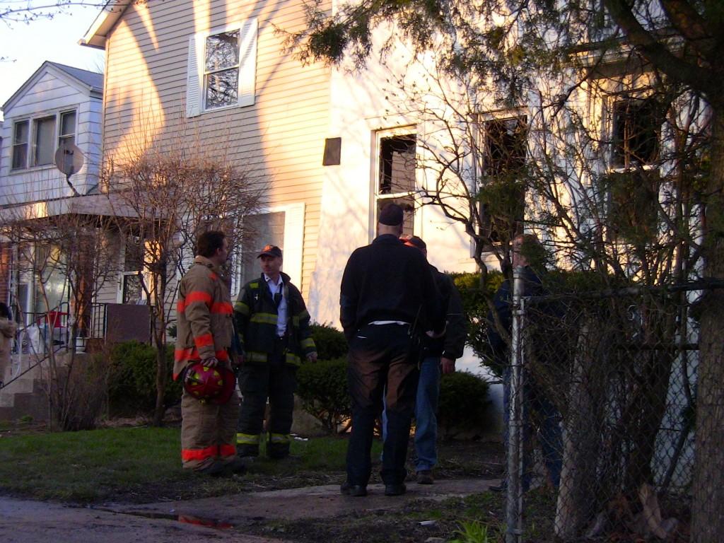 Evanston firefighters and officials examine the damage of a fire Wednesday evening. The blaze broke out in the 1900 block of Hartrey Avenue.