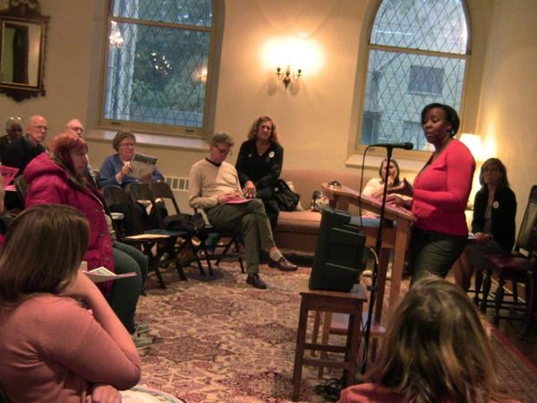 Erie Family Health Center representative Angela Sibert talks to residents Monday night about the expansion of the affordable health care services at the centers planned Hartrey Avenue and Dempster Street site.