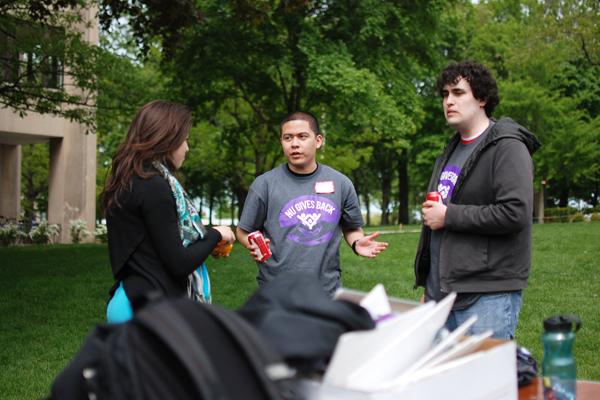 SESP junior Rebecca Rego (left), a co-president of NU Gives Back, talks Saturday afternoon with two participants, Weinberg junior Giovanni Delgado (center) and Weinberg sophomore Federico Paredes (right) about their morning of volunteering. Around 500 undergraduate and graduate students, alumni, and staff participated in the day of service this year.