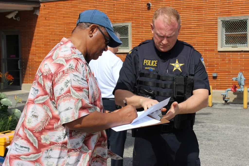 Evanston resident James Davis fills out paperwork at the city's second gun buyback event on Saturday. The three guns he traded in for $100 each brought the city's total haul to 28 firearms.