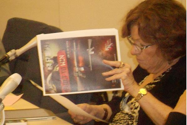Ald. Ann Rainey (8th) looks over a pamphlet handed out by an advocate for gun rights at Mondays City Council meeting. An assault weapons ban was introduced as an effort to put in place gun regulations before the states concealed-carry law possibly restricts local governments from doing so.