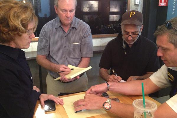 Ald. Jane Grover (7th), left, talks with Evanston reporters about Tuesday afternoons gunfire near Evanston Township High School. She was joined by Evanston Police Cmdr. Jay Parrott, far right, on Thursday at Starbucks, 1734 Sherman Ave.