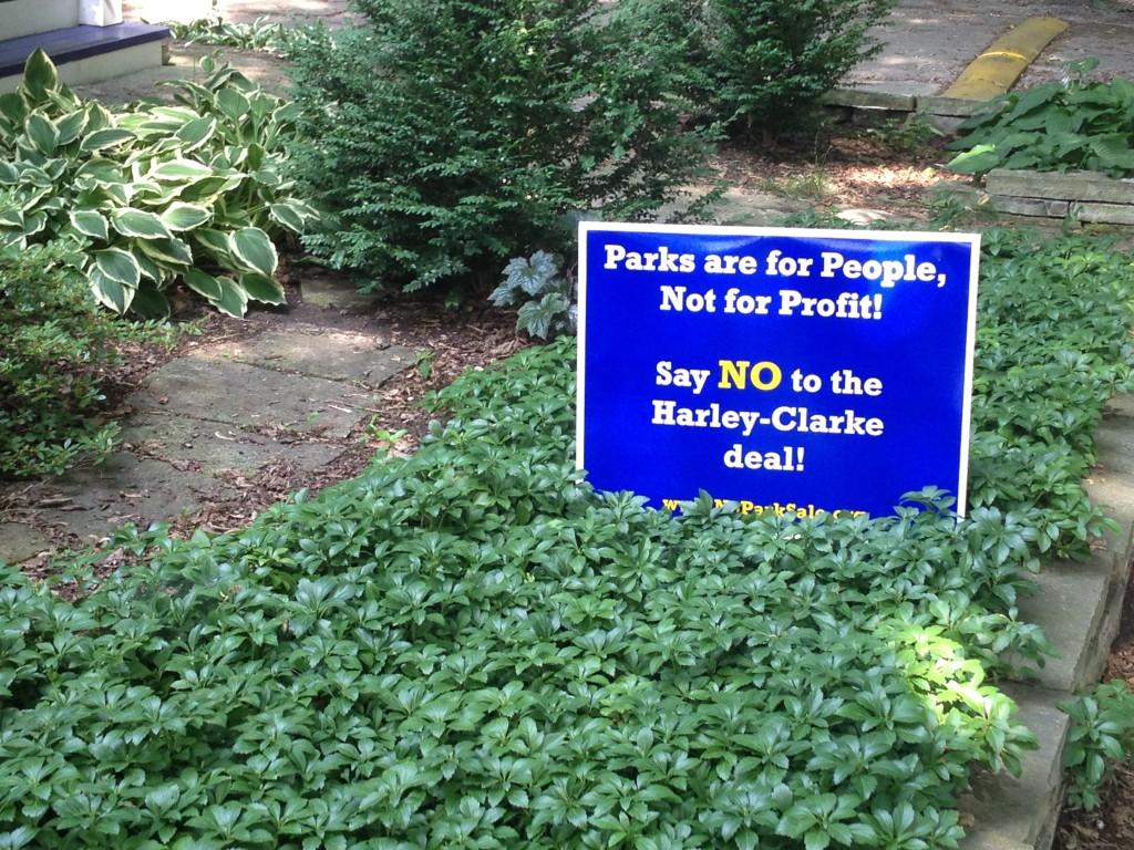 Several yard signs against the possible sale of the Harley Clarke Mansion have been planted along Central Street. The city says it can no longer afford to maintain the lakefront property.