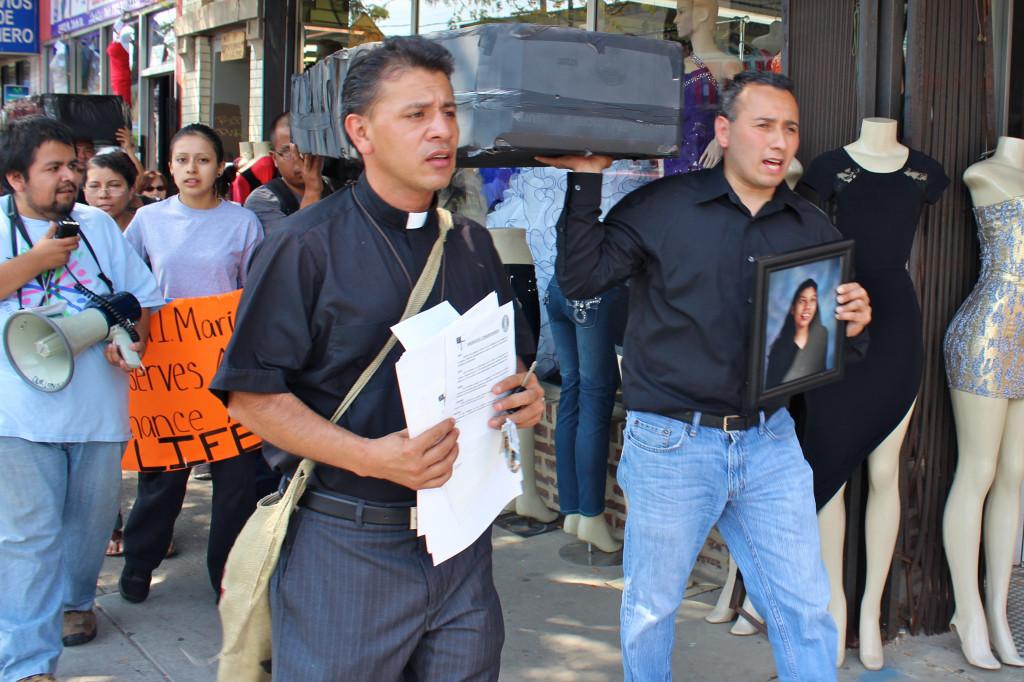 The Rev. Jose Landaverde leads about 40 protestors as they begin their march to Northwestern Memorial Hospital on Sunday afternoon. The group carried caskets to represent those who died while waiting for organ transplants.