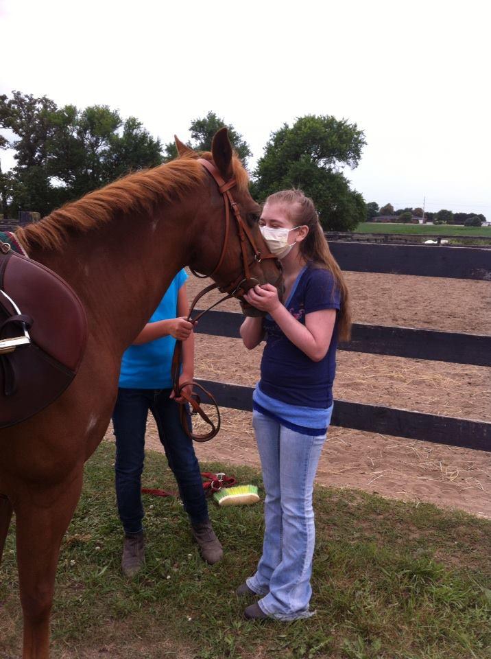 Rising Communication junior Josie Nordman visits horses Monday. Nordman, who has cystic fibrosis, is recovering from a double lung transplant July 28. 