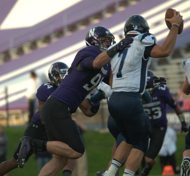 Dean Lowry gets a grip on Maine quarterback Marcus Wasilewski. The sophomore has had a very impressive campaign, nabbing one of Northwesterns pick-sixes in Saturdays game against the Black Bears. NUs coaching staff named him the Defensive Player of the Game for two consecutive weeks.