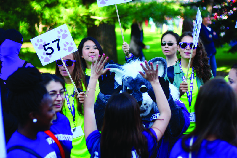 Willie the Wildcat high-fives a member of the class of 2017. New students participated in March through the Arch on Tuesday. 
