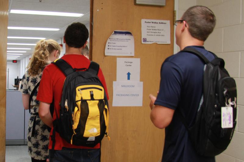 Students wait in line at the new package delivery center at Foster-Walker Complex. Residential Services officials expect lines to diminish after the rush of students receiving packages at the beginning of the year.
