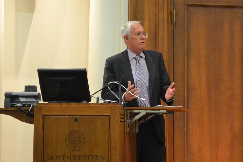 Former University President Henry Bienen introduces a panel Tuesday night at Harris Hall. Panelists discussed ways to improve education in marginalized communities.