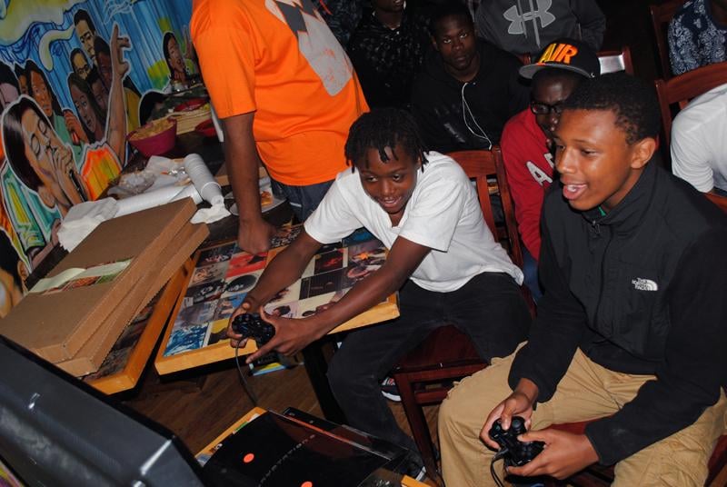 Young adults such as Damiean Walker (left) and Malik Jenkins competed for a cash prize in a video game tournament at Boocoo Cultural Center and Cafe, which was geared to provide job opportunities to Evanston youth.