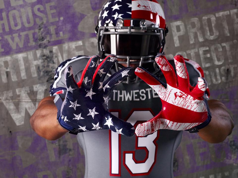 The+football+teams+uniform+for+the+Nov.+16+game+against+Michigan+features+a+red+and+blue+splattering+pattern+over+the+American+flag.+The+design+sparked+controversy+because+some+saw+it+resembling+blood.