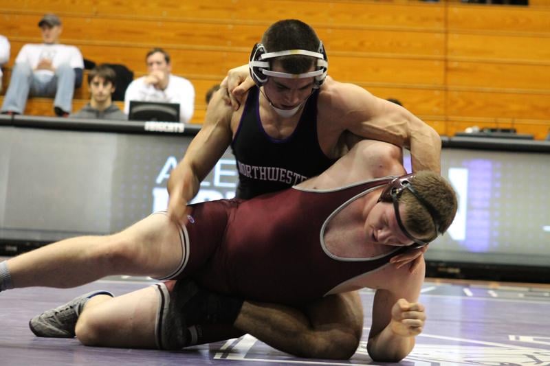 Junior Alex Polizzi takes down Jeffrey Tyburski in Northwestern’s clean sweep of Chicago on Saturday. Polizzi sealed off the match with a win by major decision and kept the Wildcats perfect in their opening match.