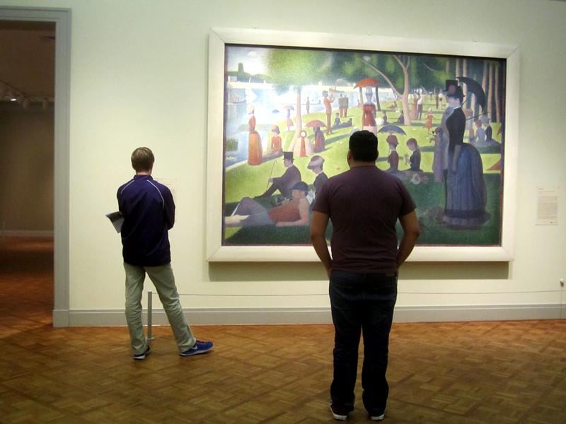 Guests at the Art Institute of Chicago observe Georges Seurats A Sunday on La Grande Jatte. The museum opened its doors Thursday to Northwestern students, faculty, alumni and friends to kick off its partnership with the University.