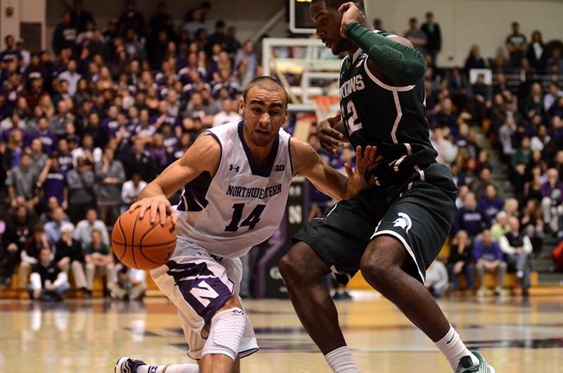 Sophomore guard Tre Demps, here holding off his Michigan State defender, has gained recognition for his clutch 3-pointers of late. Demps may be the team’s most improved player, and coach Chris Collins says his ability to break down defenses makes him a go-to leader on offense.