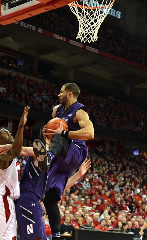 Senior guard Drew Crawford pulls in one of eight rebounds the veteran nabbed in Northwestern’s 65-56 victory at Wisconsin on Wednesday night. Crawford’s team-leading 30 points was a season high for the senior.