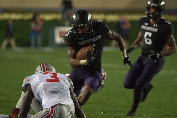 Venric Mark carries the ball in a game against Ohio State in October. The senior running back received a medical hardship waiver and will return for the 2014 season, Northwestern announced Tuesday. 