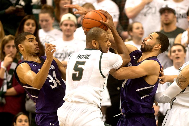 Forwards Drew Crawford and Sanjay Lumpkin battle Michigan State’s Adreian Payne for possession. Payne, who lead his team with 20 points and 14 rebounds, controlled the paint against Northwestern, leading the Spartans to an 85-70 victory. 