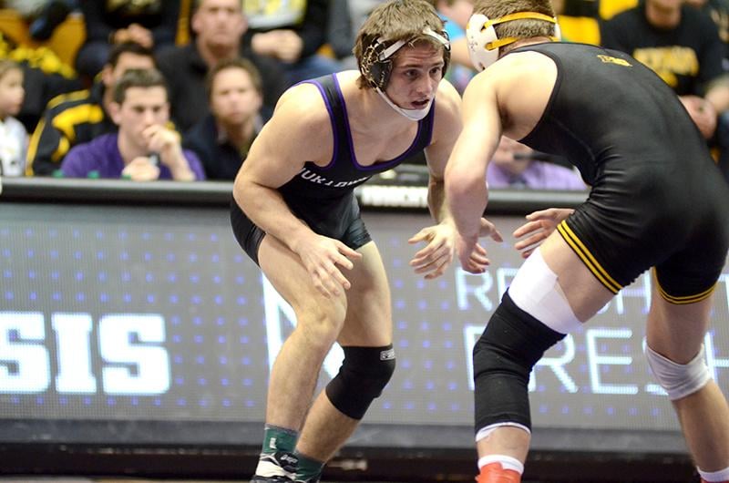 Jason Tsirtsis squares off against his Iowa opponent. The freshman, who is ranked No. 4 in his weight class, won by major decision Sunday against Stanford to improve to 22-3 on the season.