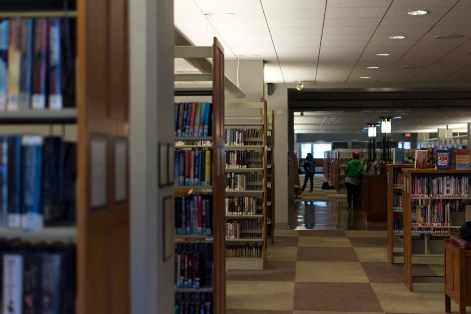 Patrons visit the Evanston Public Library on Monday afternoon. The library recently released its annual report detailing its growth and usage by the Evanston community.