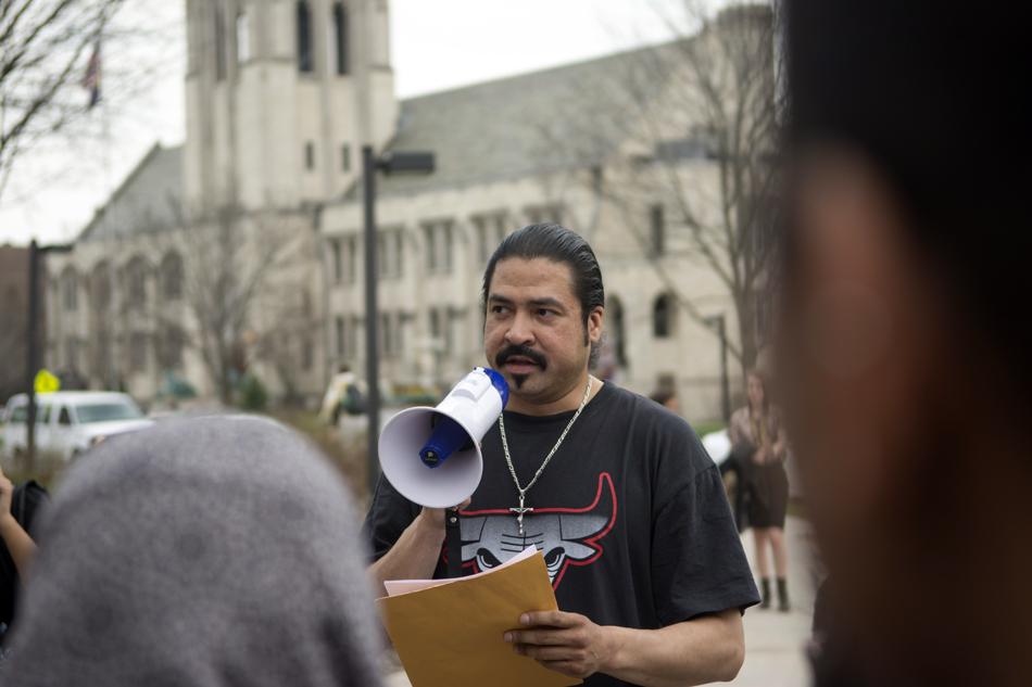 Sodexo employee Rafael Marquez addresses activists at The Arch during a rally supporting him on April 21. Marquez subsequently retained his job with Sodexo. 