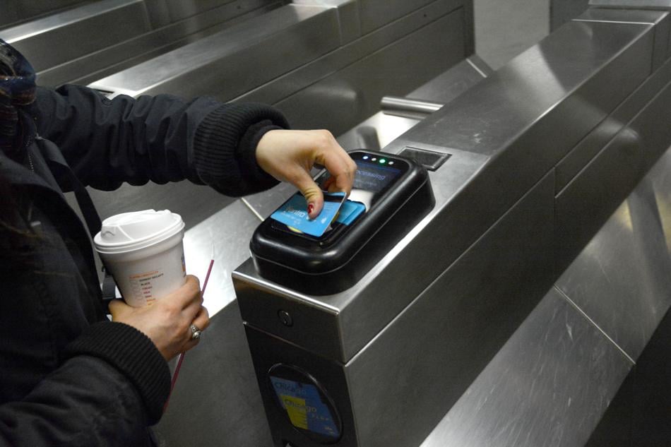 A passenger uses her Ventra card to pay for a ride on the CTA. The transit system plans to fully transition to the payment system by July.